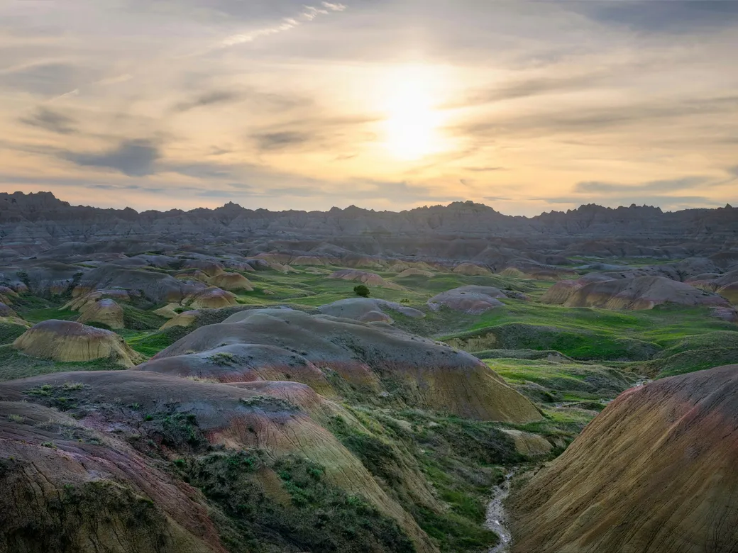 Sunrise over layered badlands terrain in South Dakota